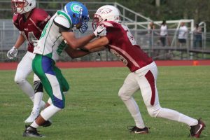 Defender Tyler Abbondanza (28) blocks a player from Coral Spring High School at a football game on Sept. 27. Photo by Lyliah Skinner