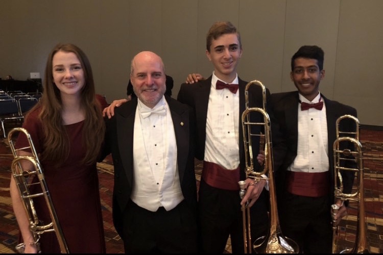 Frybergh (second from right) is seen with previous band director Alexander Kaminsky and two of his fellow trombone players. Photo courtesy of Hunter Frybergh