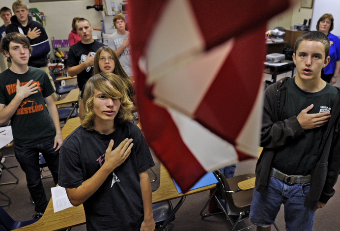 SLUG:  NA/VINCENNES:  09/08/09 CREDIT:  Linda Davidson / staff/ The Washington Post   LOCATION:  Vincennes, IN CAPTION:  Six select high schools in the US are debuting a 9-11cirriculum to their history and social studies classes.  This after families of  ( 9-11 or 9/11 or September 11th ) victims, rescuers and survivors pushed to have it added before the attack fades into distant memories for seniors who were maybe 9 or 10 when the attacks occured.  One of the select high schools is Lincoln High School in Vincennes, Indiana.  PICTURED:   Prior to 9/11, Lincoln High Schoolers did not say the pledge of allegiance.  They do now; probably the only noticeable change in this high school as well as an entry in the new history books.  Shown here, teacher Donna Kramers german class in first period saying the pledge.  StaffPhoto imported to Merlin on  Wed Sep  9 23:40:09 2009
