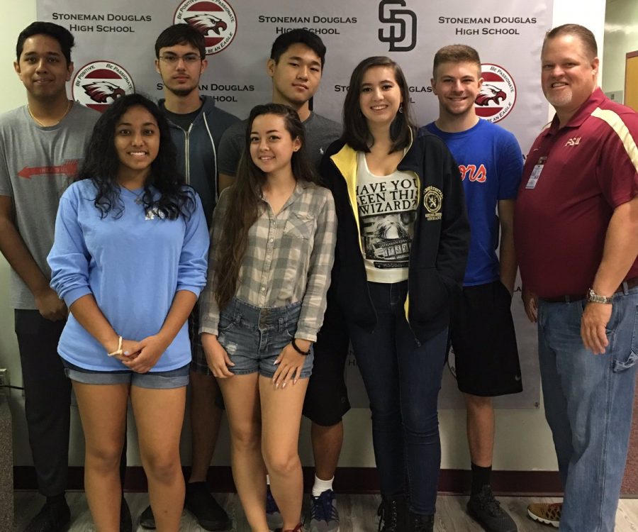 MSD national merit scholars are congratulated by Principal Ty Thompson. Photo courtesy of Ty Thompson