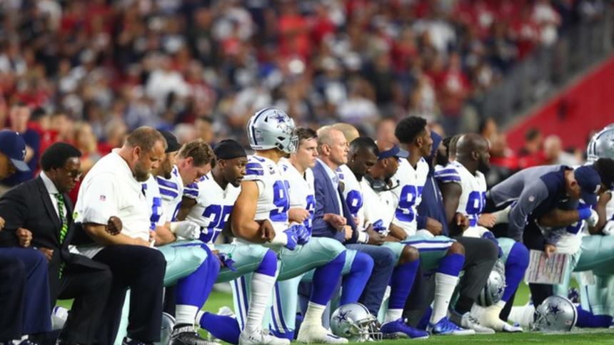 Dallas+Cowboys+lock+arms+and+take+a+knee+during+the+national+anthem+in+protest+of+police+brutality.+Photo+credit+to+Mark+J.+Rebilas-USA+TODAY+Sports