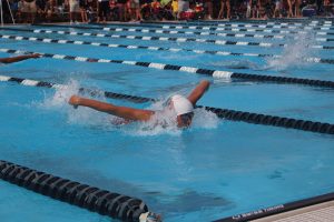 Junior Trevor Berkson swims the 100 meter butterfly. Photo by Christy Ma