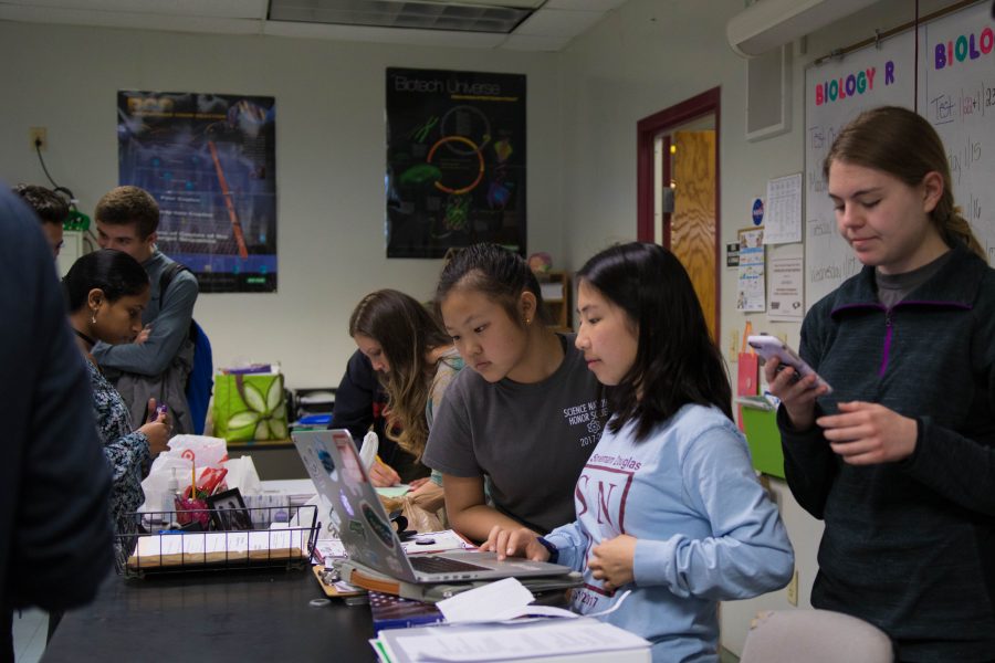 SNHS secretary Christy Ma records meeting minutes as SNHS president Nicole Anderson looks on. Photo by Delaney Tarr