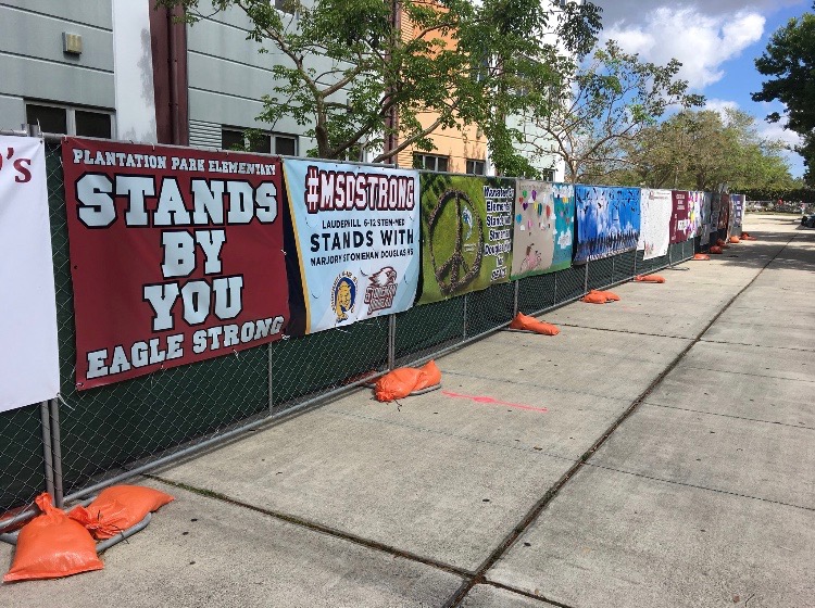 Banners from Broward County schools and organizations around the country decorate the fence surrounding the perimeter of the 1200 building. 
