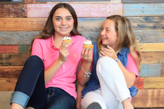 Gwyneth Bishara and Ella Bishara hold cupcakes to represent Gwyneth's organization, Cupcakes for Charity. Photo courtesy of Evelyn Robles, Lifestyle Media Group