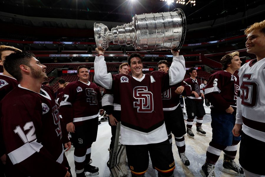 Assistant captain Tyler Avron hoists the Stanley Cup after the Eagles win their first state championship. 