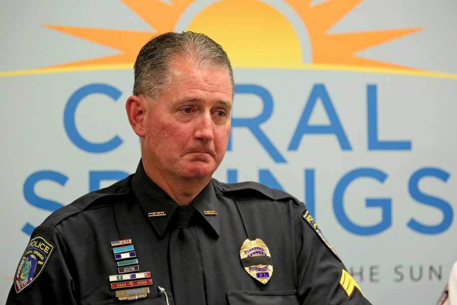 Coral Springs Police Sgt. Jeff Heinrich breaks down talking about his wife and son during a news conference at the Coral Springs Police Department on Friday, Feb. 23, 2018. Heinrichs wife, Marilyn, is the Assistant Athletic Director at Marjory Stoneman Douglas High School and his son is a student there. (Amy Beth Bennett/South Florida Sun Sentinel/TNS)