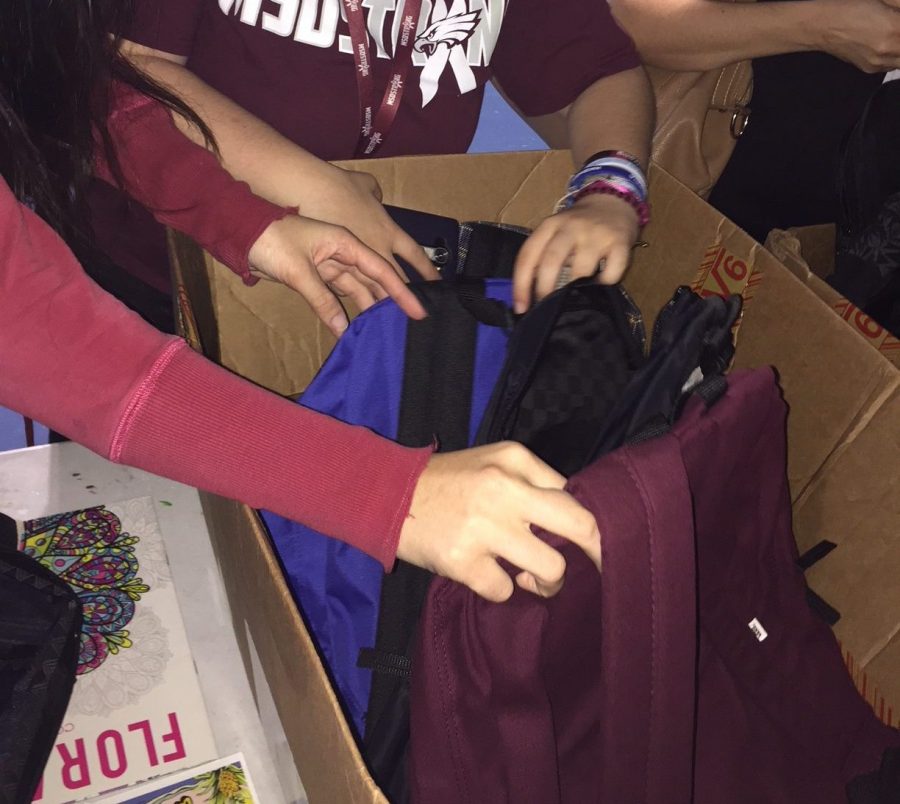 Junior Shai Harnov picks out her free Vans backpack. Photo by Lauren Newman
