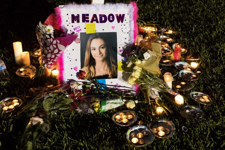 A photograph of Meadow Pollack at the base of one seventeen crosses at a candlelight vigil for the victims of the  shooting at Marjory Stoneman Douglas High School, in Parkland, Fla, on February 16, 2018 (Greg Lovett/The Palm Beach Post/Zuma Press/TNS)