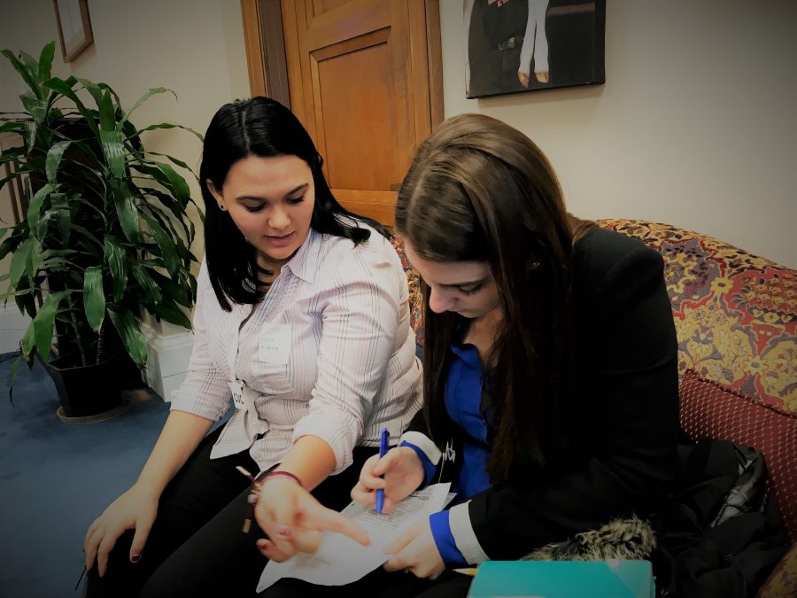 Sophomore Dara Rosen and junior Rebecca Schneid jot down potential questions for Sen. Bernie Sanders outside his office in Washington, D.C. Photo by Melissa Falkowski.