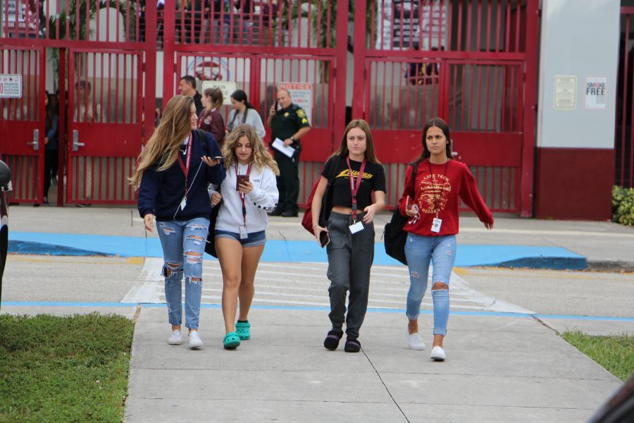 Freshmen Kelly Cooke, Carli Komroff, Alex Heller and Sofia Cardona walk out of school on Tuesday, Nov. 27 to protest the recent administrative changes. Photo by Dara Rosen