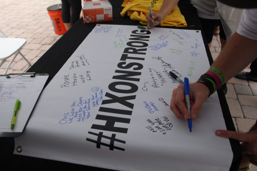 Runners sign #Hixonstrong banner to show their support. Photo By: Samantha Goldblum