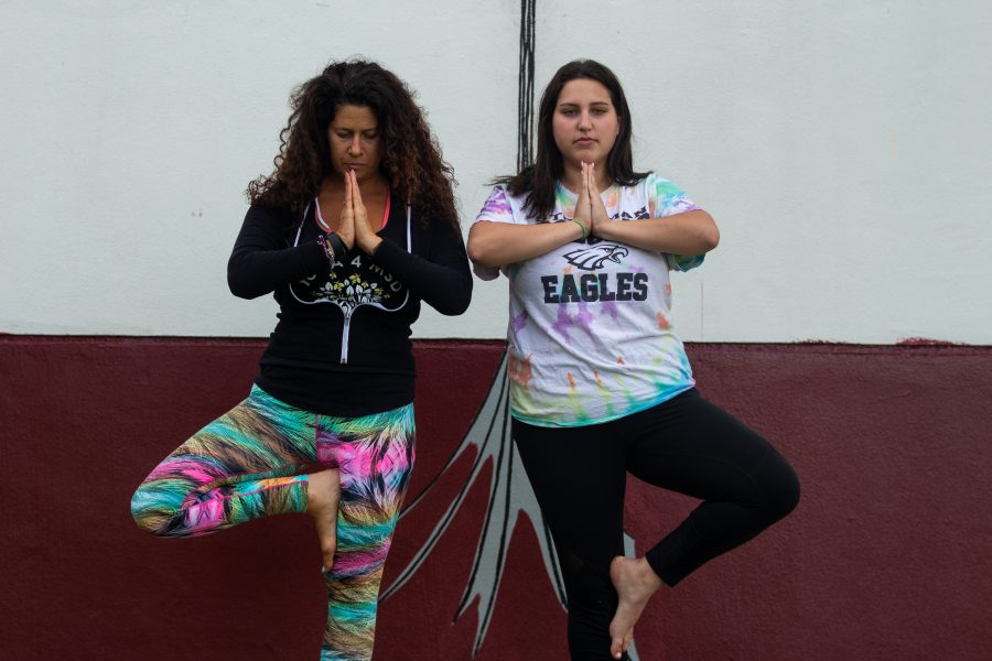 Hayley Siegel and Amy Kenny relax through yoga.