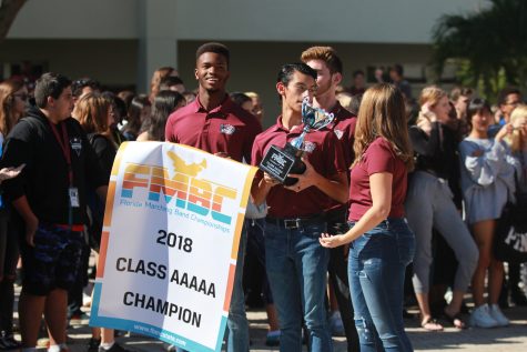 On Tuesday, Nov. 20 band officers, senior Steven Blake, juniors Nico Fraiser and Angelina Brier and sophomore Jeremy Weschler, show off their state trophies to MSD students and staff. Photo by Nyan Clarke