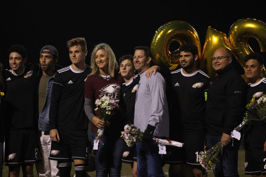 From left to right: Full-back Bryan Herrera (8), midfielder Cole Leonardi (9), striker Justin Brod (7), defense Lucas Magalhaes (12), and midfielder Juan Munera (21) pose for a senior night photo with their parents.