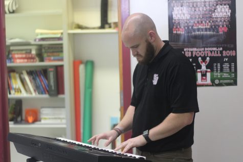 Mr. Schaller has a piano in his classroom to link his love of music with his passion for teaching. Photo by Darian Williams