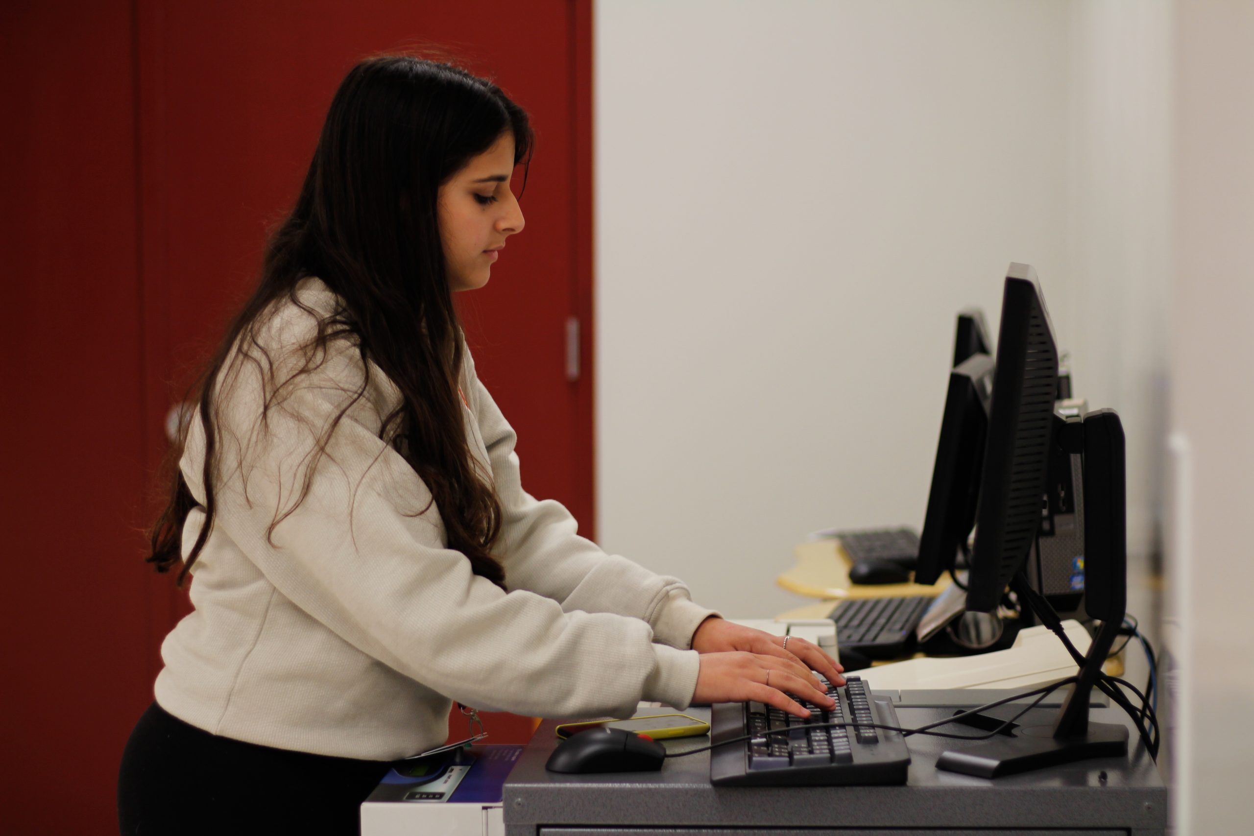 Junior Einav Cohen demonstrates using the new print station in the cafeteria, which was installed on Oct. 10. The station is available for use every day. Photo illustration by Nyan Clarke