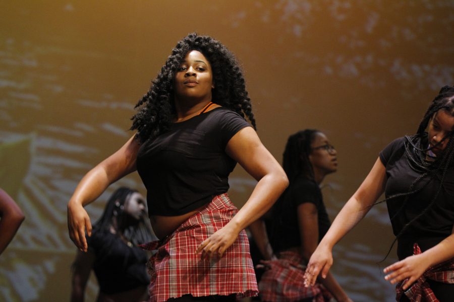 Senior Mei-Ling Ho-Shing moves to the beat during the Jamaican performance at the Dec. 11 multicultural show. Photo by Nyan Clarke