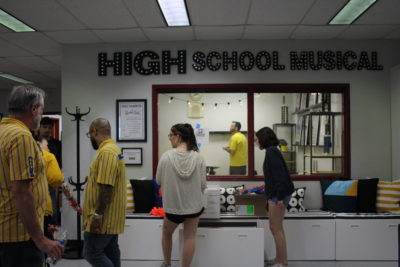 Ikea workers dressed in yellow shirts and MSD drama students begin the organization process for the newly done classroom. Photo by Einav Cohen