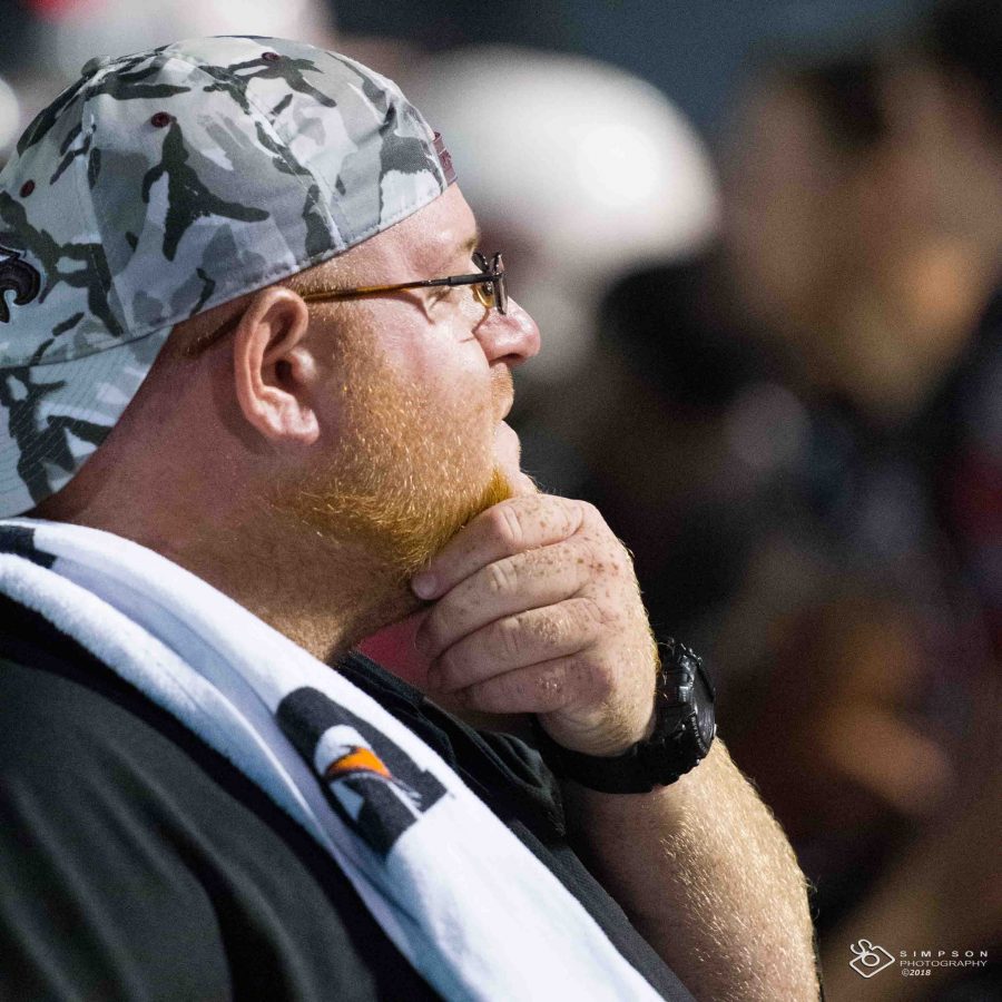 For Feis. Coach Aaron Feis watches a Varsity football team game from the sidelines. The guardian program was named after Feis, who died after rushing to aide students and teachers as a shooting unfolded on Feb. 14, 2018 at Marjory Stoneman Douglas High School. Photo courtesy of Sean Simpson