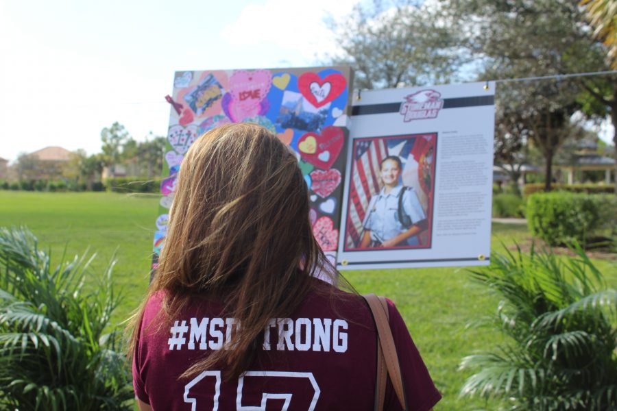 In Remembrance. English teacher Stacey Lippel stops to remember Alaina Petty. Lippel stopped at every panel to remember each of the 17 students and faculty who were memorialized in the Parkland Hearts panels. Photo by Farrah Nickerson