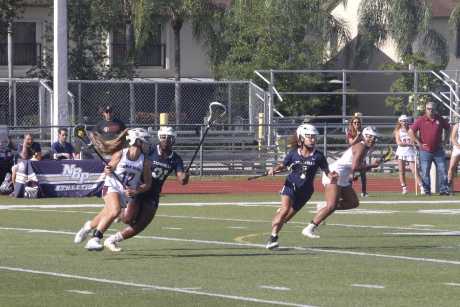 Attacker Lauren Figas (12) dodges Taravella players down the field. Photo by Kaleela Rosenthal