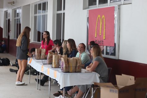 Guidance Director Veronica Ziccardi and her department hands out McDonalds meals to students who received Straight A's first quarter on Friday, Nov. 8. Photo by Darian Williams