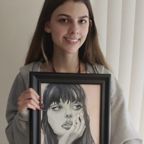 Sophomore Faith Hartwig shows off the portrait she won with at the Broward All Stars Exhibition.