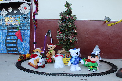 An elaborate design complete with a train track, mini tree, and stuffed animals, sits outside of Penny Paganos door.
