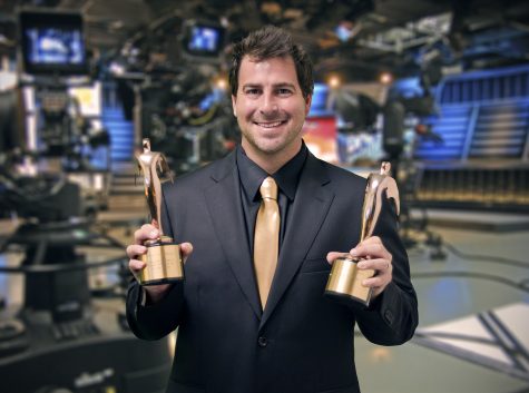 Evan Golden displays two of his awards on the set of  Eye on South Florida . Photo Courtesy of Jack Namer