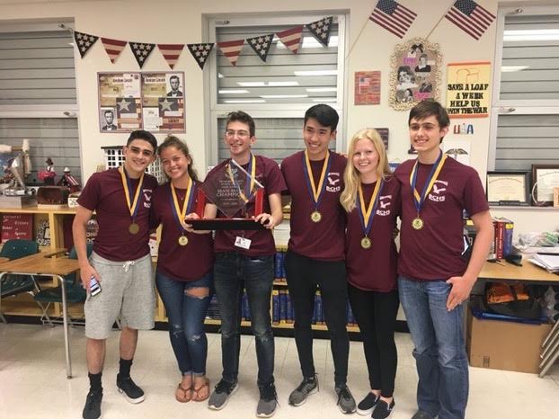 MSD Brain Brawl team gathers as Senior Max Kilman hoists championship trophy. Photo courtesy of MSD Brain Brawl