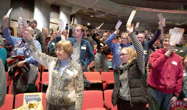 Iowa Caucus goers raise their hands. Caucus-goers raise their hands to be counted during the caucuses at Stephen Auditorium Monday, Feb. 3, 2020, in Ames, Iowa.