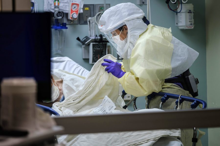 Wearing personal protective equipment, nurse April Bandi cares for a patient under investigation with possible COVID-19 symptoms inside a special negative pressure isolation room at the Emergency Department at Sharp Memorial Hospital on April 10, 2020 in San Diego, Calif. (Marcus Yam/Los Angeles Times/TNS)