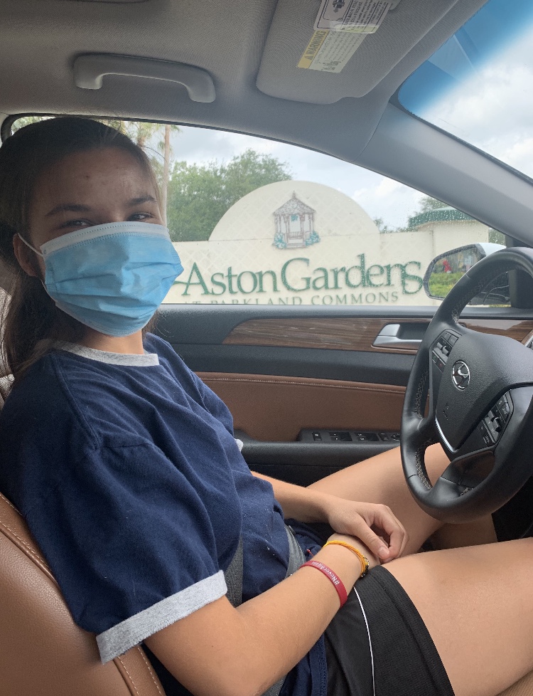 Key Club’s Aston Gardens committee head Lindsey Salomone delivers letters outside the Aston Gardens facility.