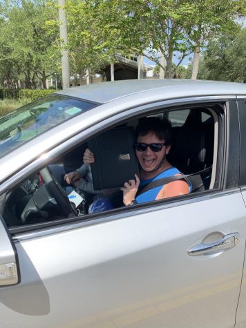 Senior Hunter Dorman collected his stole and present from a drive-by hosted by DECA officers. Photo courtesy of Katelyn Taylor