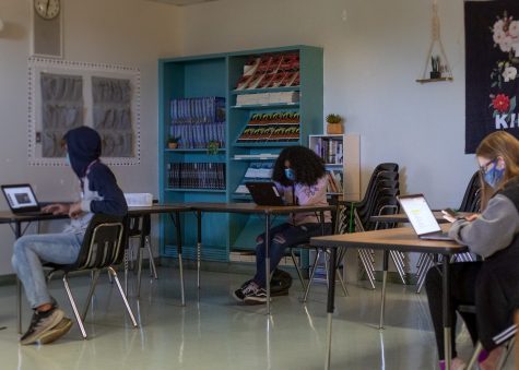 Students in classroom working while socially distant