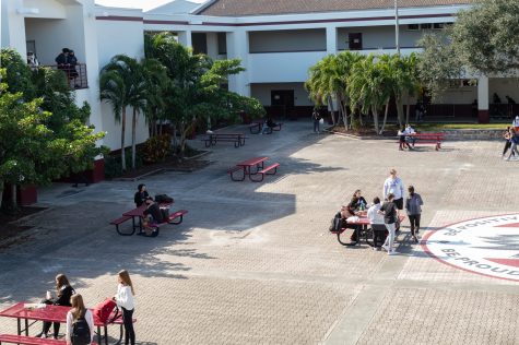 students sit outside in courtyard for lunch