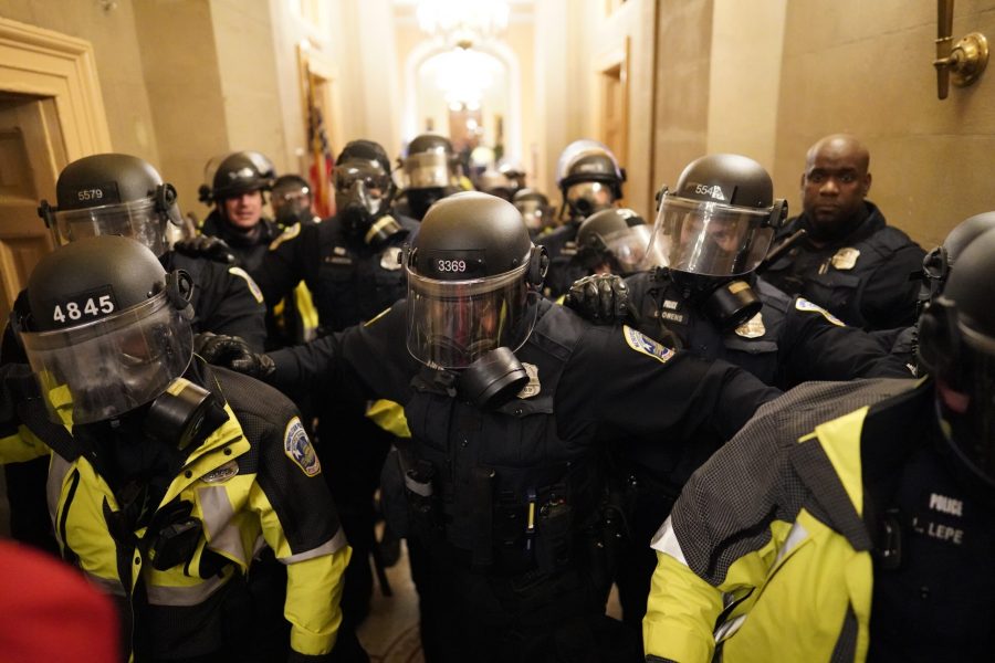 Riot police clear the hallway inside the Capitol on Wednesday, Jan. 6, 2021 in Washington, DC. (Kent Nishimura/Los Angeles Times/TNS)
