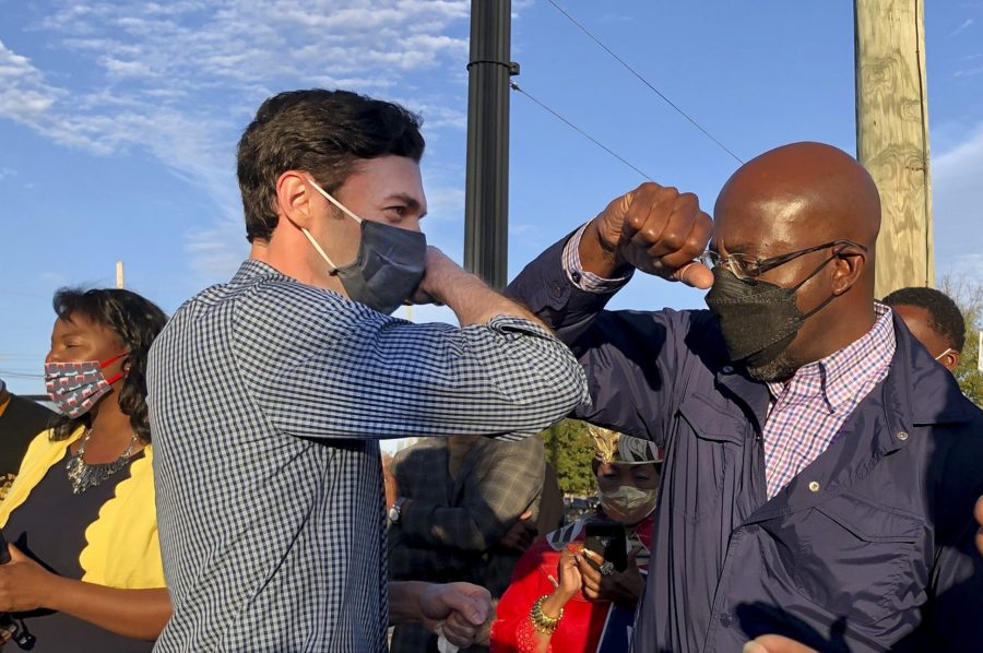 Democratic U.S. Senate candidates Jon Ossoff, right, and Raphael Warnock, left, of Georgia tap elbows during a rally for supporters on Nov. 15, 2020 in Marietta, Georgia. Both become senators Wednesday.  (Jenny Jarvie/Los Angeles Times/TNS)