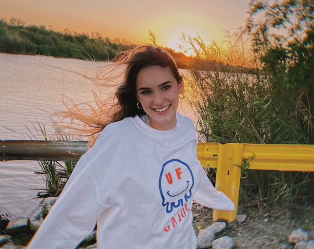 Lexie Sealy stands in front of river in University of Florida gear.