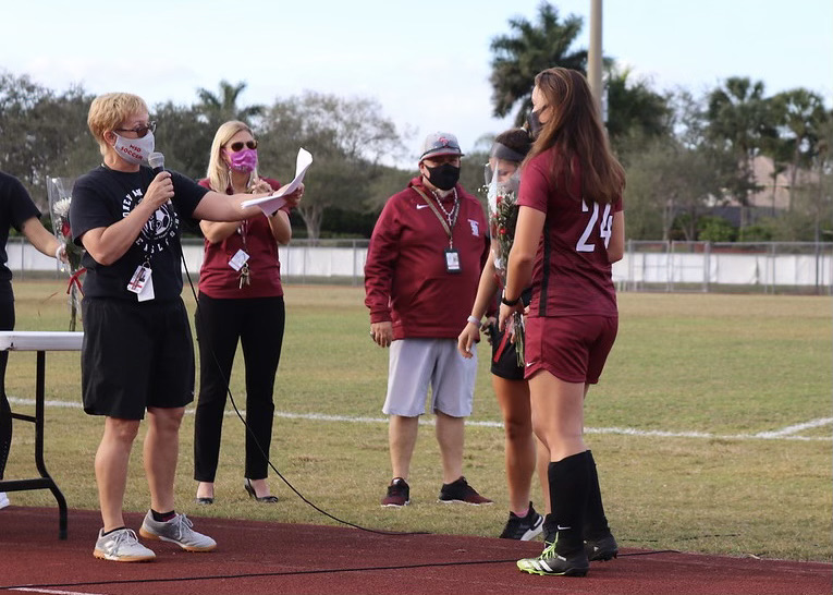 Inspiring the Team to Success. Coach Laura Rountree celebrates senior defender Jordan Carrey (24) on the Eagles senior night. Rountree prepared words for Carrey and the other 4 seniors on Girls Varsity Soccer during the Jan. 25 senior night. Photo by Bryan Nguyen.