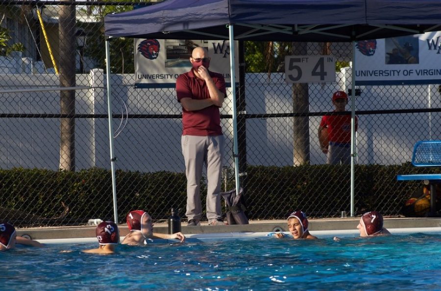 Coaching. Water polo coach Jacob Abraham talks to his team on the side of the pool during a game against West Minster Academy. Photo Maria Jose Vera.   
