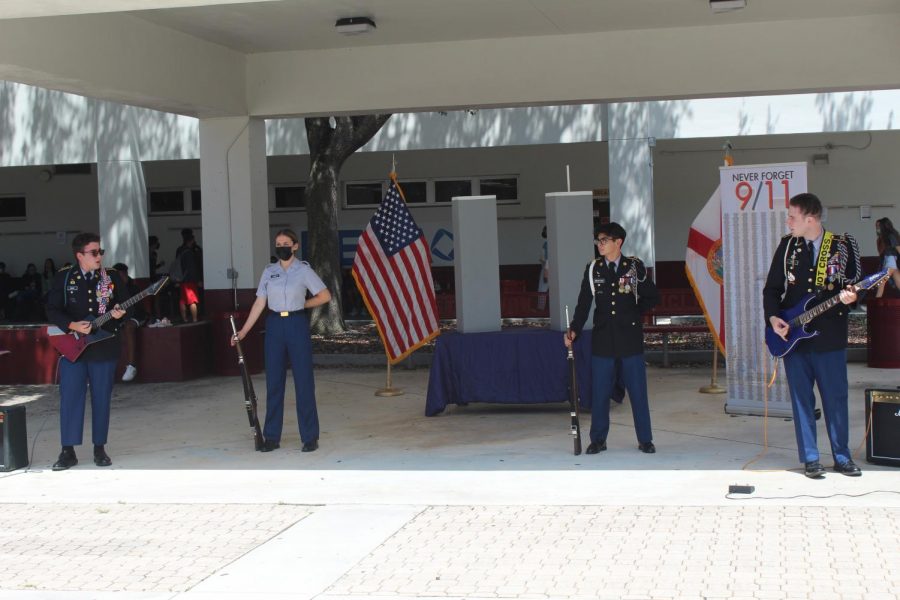 Seniors Mason Wank and Chris Krok captivates the attention of students with their electrifying musical show as seniors Elaina Wood and Anthony Aguilar stand by during lunch. The commemorative ceremony hosted by the JROTC program paid tribute to the mournful day on Sep. 11.