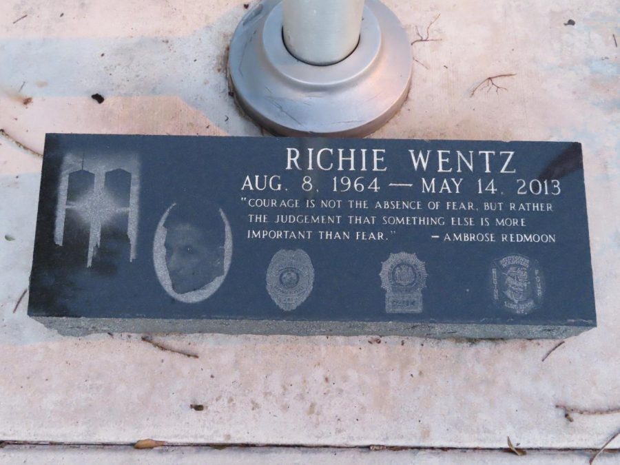 A+plaque+honoring+the+late+Richard+Wentz+rests+at+the+base+of+the+flagpole+in+front+of+Marjory+Stoneman+Douglas+High+School.+His+dedication+and+sacrifice+being+a+member+of+the+New+York+Police+Department+is+worth+remembering+as+he+rescued+victims+of+the+terrorist+attacks+on+Sep.+11%2C+2001.