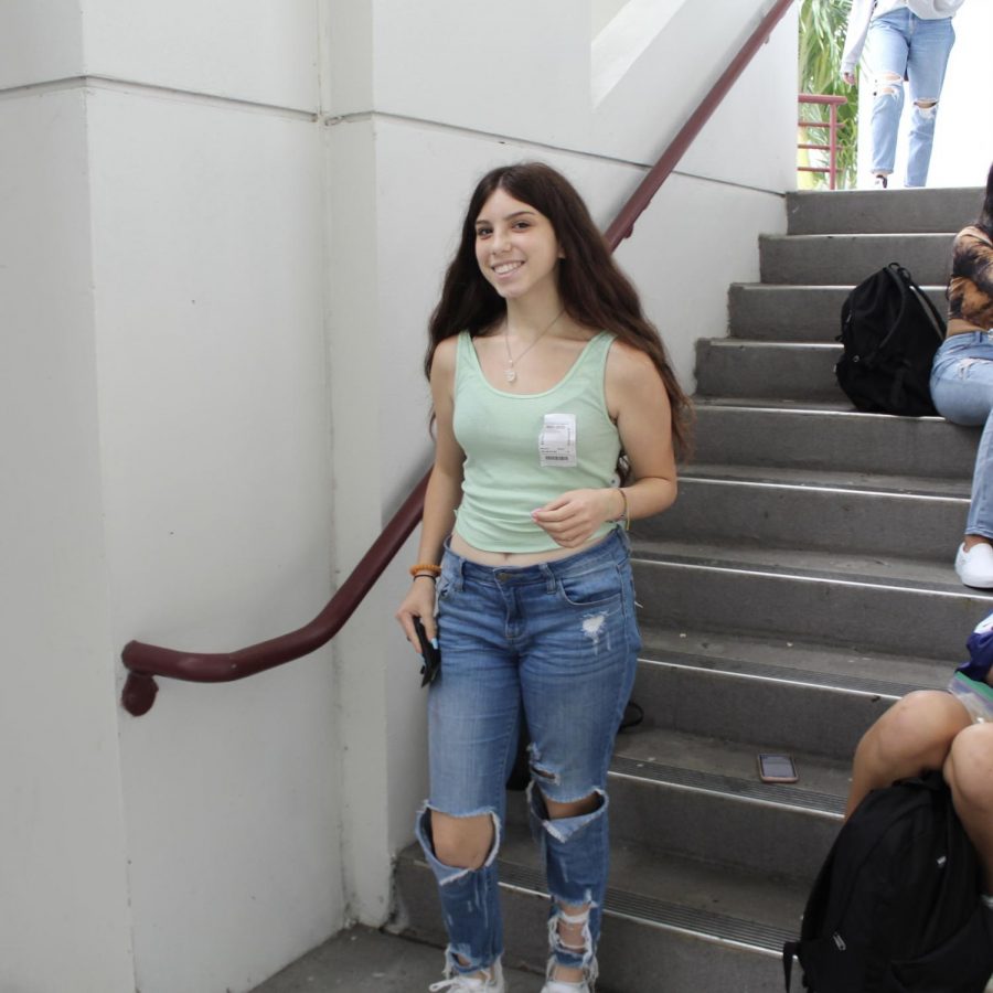 Sophomore Dana Bercun poses in her mom jeans during lunch. Along with many other teenage girls, she styles her mom jeans with a pair of Nike Air forces and a colorful tank top.