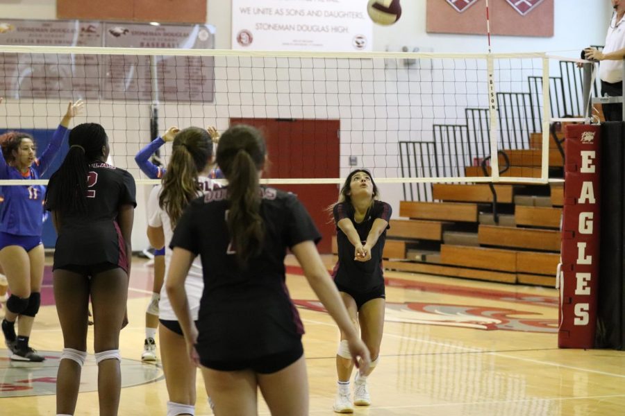 Junior Isabel Gonzalez sets up the ball for her fellow teammates to slam against the Hollywood Hills Spartans. The Eagles ended up winning the match 3-0.