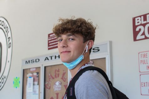 Junior Ty Stevens listens to music through his AirPods on his way to class.