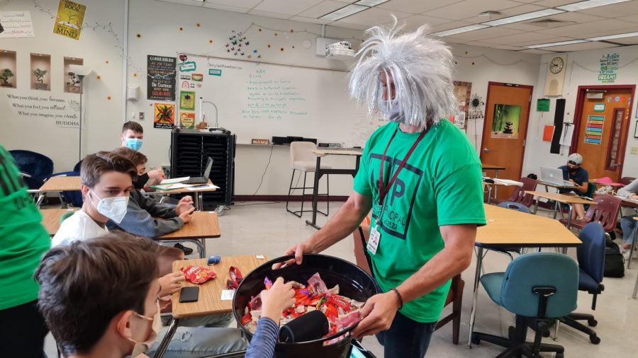 Assistant Principals David Lecthman and Kristine Knap hand out candy to students in the 200 building classrooms during second period on Oct. 28 before the Halloween weekend.