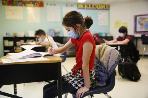 Fifth grader Evelyn Duran works on a writing assignment ONeal Elementary School in Elgin Friday. The district superintendent is among hundreds in Illinois who want standardized testing waived this spring. Photo courtesy of Stacey Wescott
