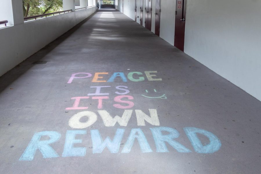Peace is its own reward. Peer counseling students write happy chalk messages across campus.